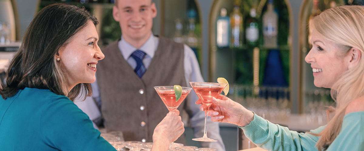 Two women enjoying cocktails in the Belvedere Lounge on Spirit of the Danube
